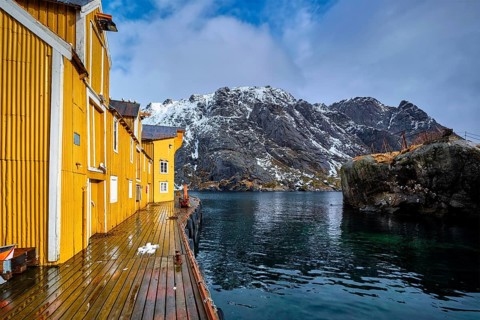 Nusfjord authentic fishing village in winter with red rorbu houses. Lofoten islands