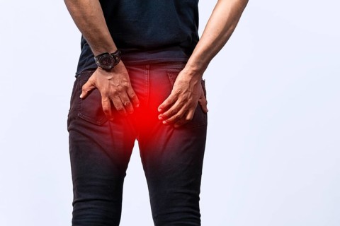 People with digestive problem touching his buttock