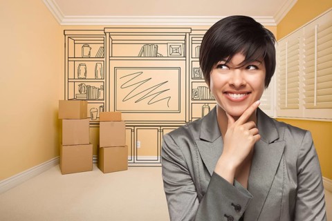 Young mixed-race female looking to the side in room with drawing of entertainment unit on wall