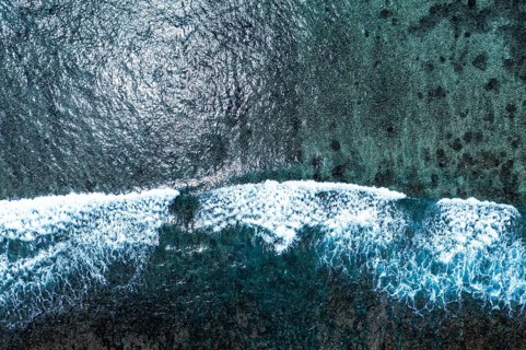 Aerial view of Flic en Flac beach with waves on the reefs