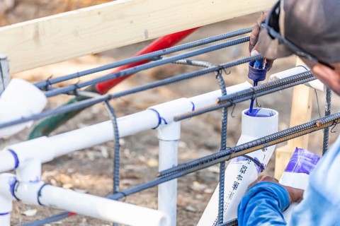Plumber applying pipe cleaner