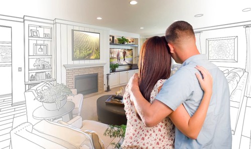 Curious young military couple looking over custom living room design drawing photo combination