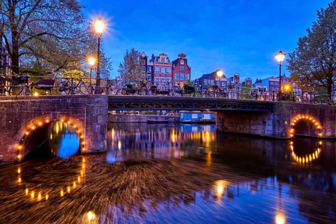 Night view of Amterdam cityscape with canal