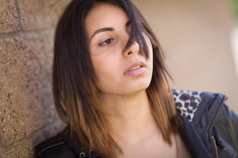 Beautiful meloncholy mixed-race young woman portrait outside