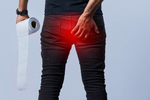 People with toilet paper in hand touching his buttock