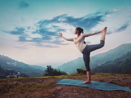 Woman doing yoga asana Natarajasana