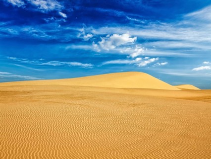 White sand dunes in desert on sunrise