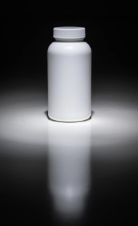 Blank white bottle ready for your text under spot light
