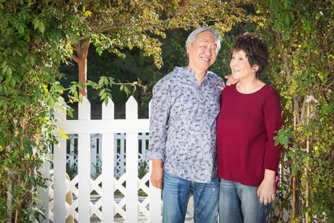 Attractive happy chinese couple enjoying their house outside