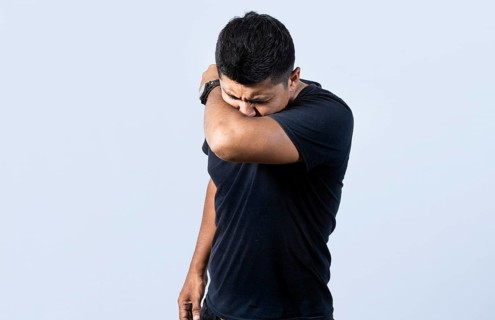 People sneezing with his elbow