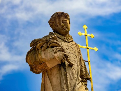 Sculpture of the patron saint Peter in front of the Einhard Basilica St. Marcellinus and Peter