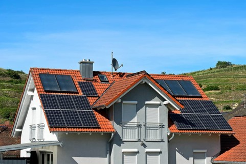 Single-family house with thermal solar system for hot water and solar panels for electricity generation on the roof