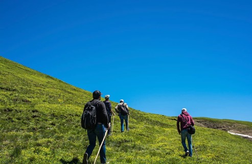 Hikers with backpacks and trekking poles walking in Turkish highland