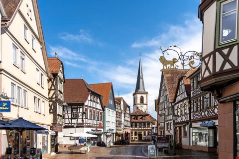 View of the pedestrian zone with church in the old town of Lohr am Main with half-timbered houses