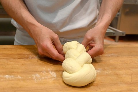 Bakers plaiting butter plait