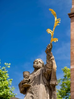 Sculpture of the patron saint Marcellinus in front of the Einhard Basilica of St. Marcellinus and Peter
