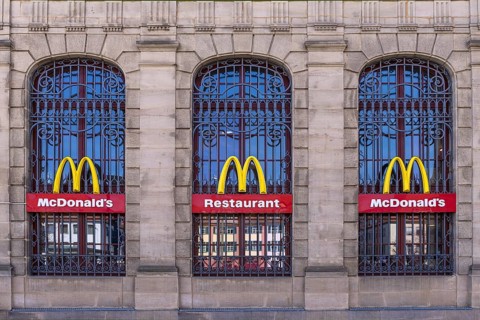 Mc Donald logos on the windows of a historic post office building