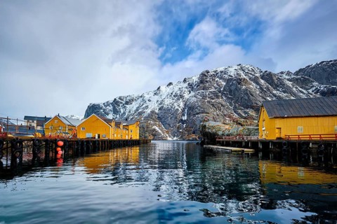 Nusfjord authentic fishing village in winter with red rorbu houses. Lofoten islands