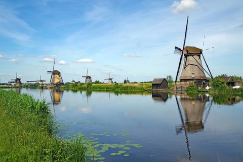 Historic windmills reflected in a canal