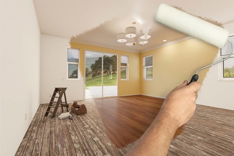 Before and after of man painting roller to reveal newly remodeled room with light yellow paint and new floors