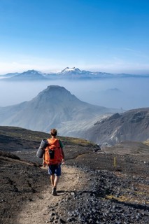 Hikers on hiking trail through volcanic landscape