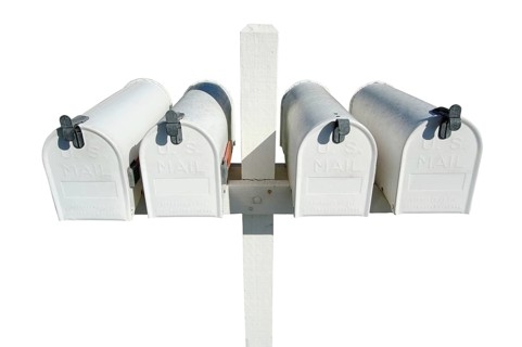 Row of white mailboxes isolated on a white background