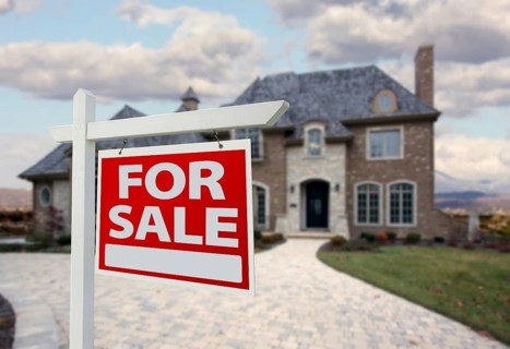 Home for sale sign in front of new house