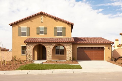 A newly constructed modern home facade and yard