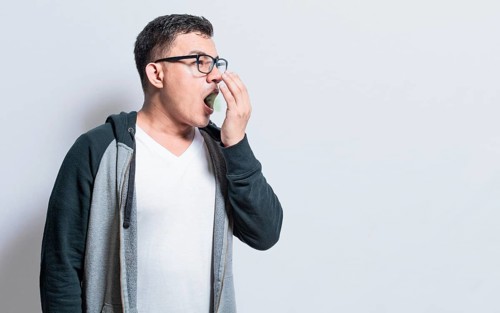 Handsome man with bad breath and halitosis problem