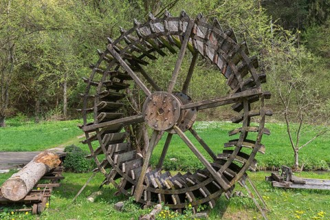 Disused mill wheel set up as decoration at a mill