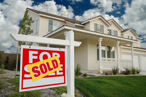 Sold home for sale sign in front of new house