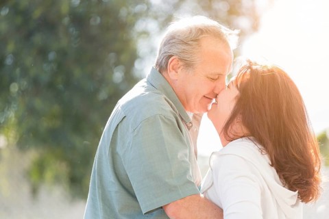 Happy middle aged couple enjoy A romantic slow dance and kiss outside