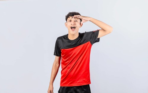 Amazed young man with his mouth open with his hand on his forehead