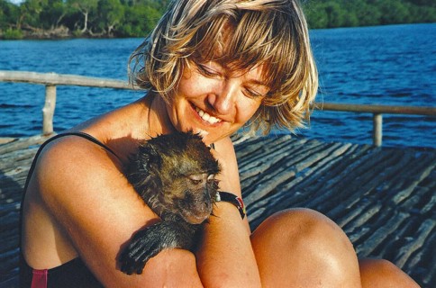 Woman holding wet baboon