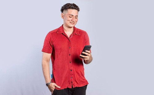 Handsome guy happy with his cell phone