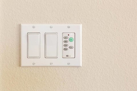 Light switches and fan control on wall of home