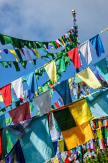 Buddhist prayer flags lungta with Om Mani Padme Hum Buddhist mantra prayer meaning Praise to the Jewel in the Lotus on kora around Tsuglagkhang complex