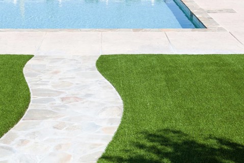 New artificial grass installed near walkway and pool