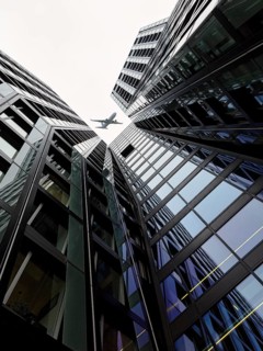 Aeroplane over two skyscrapers