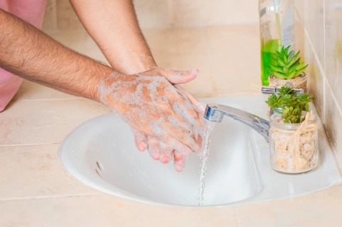 Close up of a man washing their hands with soap