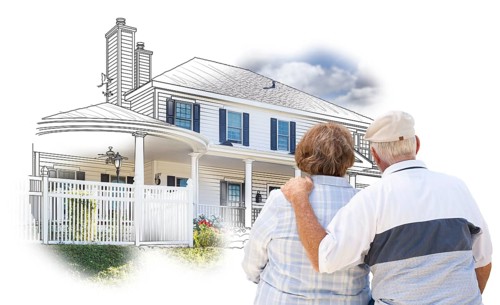 Curious embracing senior couple looking at house drawing and photo combination on white