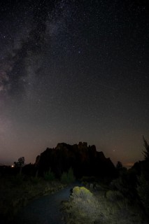 Lighted path and canyon against night sky