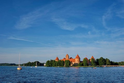 Trakai Island Castle in lake Galve with boats and yachts in summer day with beautiful sky