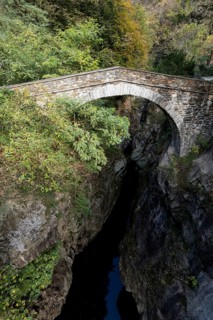 Old stone bridge over the river Cannobino