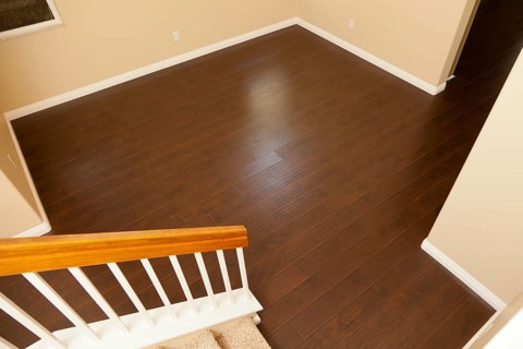Beautiful newly installed brown laminate flooring and baseboards in home