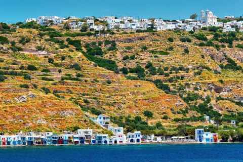 Klima and Plaka villages with whitewhashed traditional houses and orthodox church and windmills on Milos island