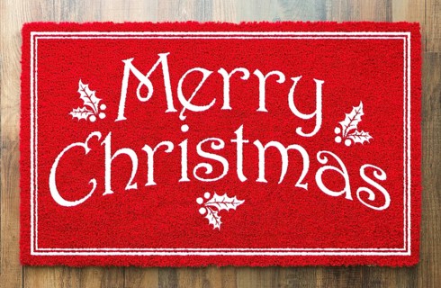 Merry christmas red welcome mat on wood floor background
