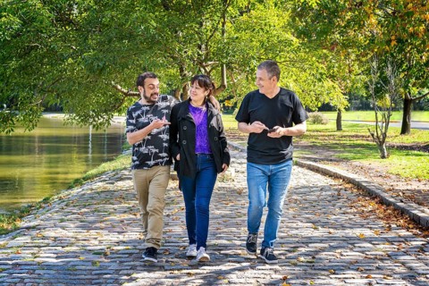 Group of friends walking in a park chatting