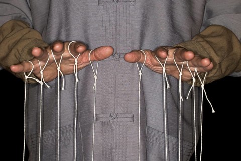 String-pulling puppeteer with Chinese shirt
