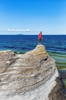 Hiker standing on limestone column